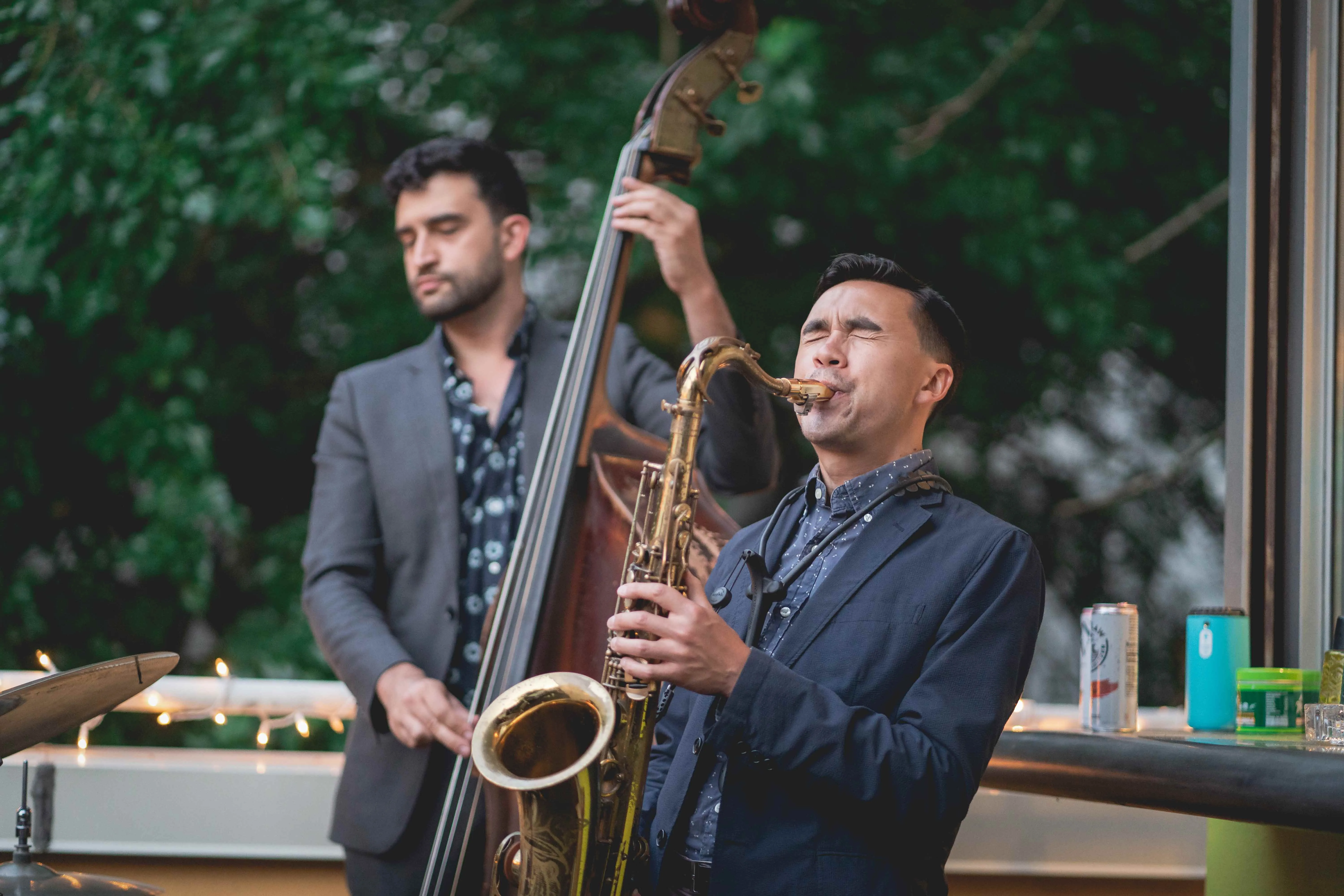 Saxophonist and bassist playing live music at Enigma Haus NYC.